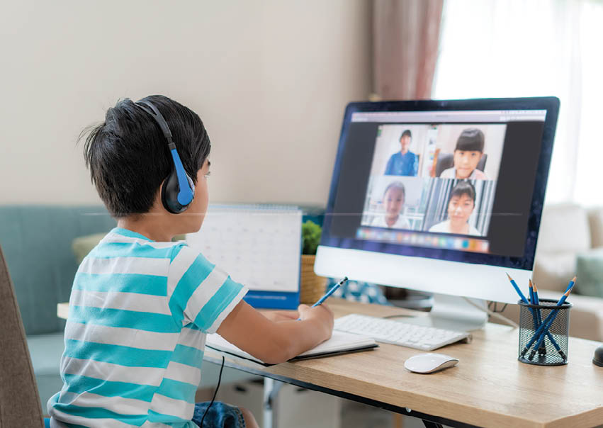 Asian boy student video conference e-learning with teacher and classmates on computer in living room at home. Homeschooling and distance learning ,online ,education and internet.